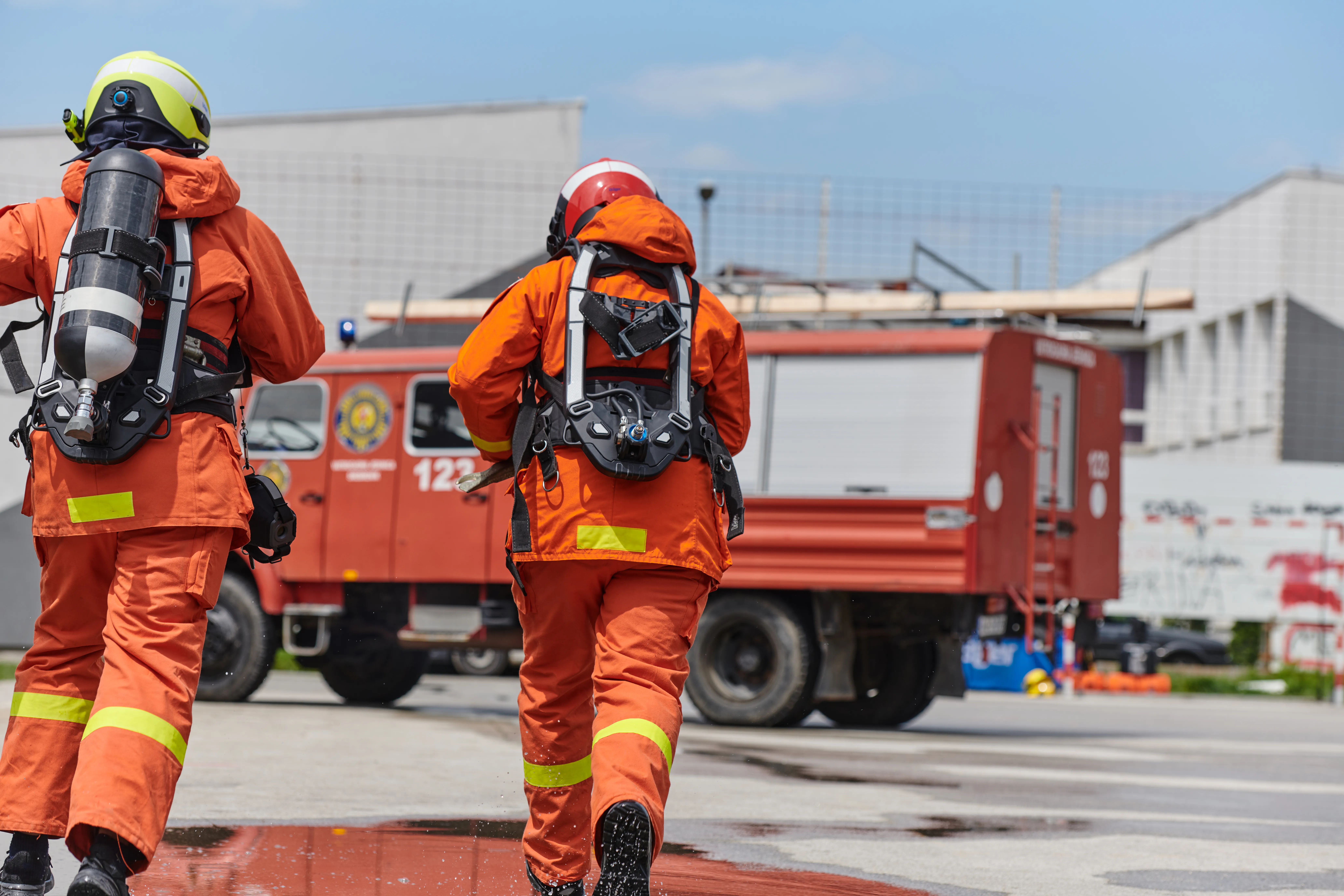 Firefighter Team Training with Various Tools in Professional Gear